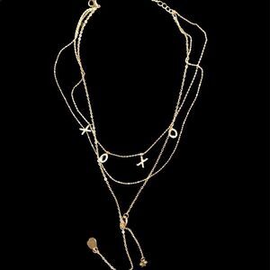 Pave crystal XOXO multi stand gold necklace with lariat detail